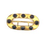 AN AESTHETIC MOVEMENT GILDED BELT BUCKLE MOUNTED WITH EIGHT CABOCHON BANDED AGATE. LENGTH 7.5cms.