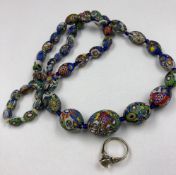A VINTAGE STRING OF GRADUATED VENITIAN GLASS BEADS, CONTINUOUSLY KNOTTED WITH BLUE GLASS ROUNDLES,