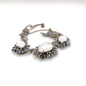 A VINTAGE COSTUME PASTE NECKLACE. FOUR FOLIATE STYLE CLUSTERS INDIVIDUALLY SET SUSPENDED ON A