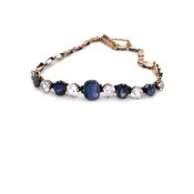 AN ANTIQUE 9ct GOLD BLUE AND WHITE SAPPHIRE GRADUATED BRACELET. THE MIXED CUT BLUE SAPPHIRES IN FOUR