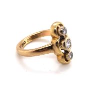 A 9ct YELLOW GOLD HALLMARKED THREE STONE RUBOVER SET DIAMOND TRILOGY RING. DATED 1997, LONDON. THE