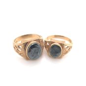 A PAIR OF HIS AND HERS HEMATITE INTAGLIO TROJAN HEAD CARVED RINGS. STAMPED 9ct , FOR SGW, AND