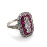 AN ART DECO STYLE RUBY AND DIAMOND PANEL RING. THE THREE CENTRAL OLD CUT DIAMONDS APPROX ESTIMATED