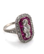 AN ART DECO STYLE RUBY AND DIAMOND PANEL RING. THE THREE CENTRAL OLD CUT DIAMONDS APPROX ESTIMATED