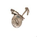 A VINTAGE PORTRAIT LOCKET THE OUTER COVER DEPICTING A PARAKEET ON A BRANCH, SUSPENDED ON A PRICE