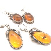 TWO PAIRS OF FOLIATE STYLE AMBER DROP EARRINGS ON SILVER WIRES. UNHALLMARKED AND ASSESSED AS SILVER.