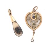 A VINTAGE ALMANDINE GARNET AND PERIDOT WIREWORK HEART PENDANT. UNHALLMARKED AND ASSESSED AS 9ct