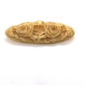 AN ANTIQUE CARVED IVORY FLORAL BROOCH. LENGTH 6.5cms.