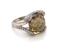 A SMOKY QUARTZ AND DIAMOND DRESS RING. UNHALLMARKED AND STAMPED 585, 14K, AND ASSESSED AS 14ct GOLD.