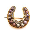 A VICTORIAN DIAMOND AND PEARL HORSESHOE BROOCH. THE THIRTEEN GRADUATED MULTI GREY / PEACH TONED SEED