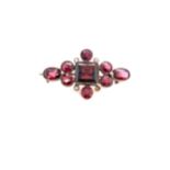 AN ANTIQUE ALMANDINE GARNET AND SEED PEARL BROOCH MOUNTED IN ROSE COLOURED METAL. MEASUREMENT 3.4