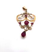 AN EDWARDIAN RHODOLITE GARNET AND SEED PEARL DROP PENDANT. THE REVERSE STAMPED 9ct, AND ASSESSED