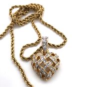 A SWAROVSKI CRYSTAL AND GOLD PLATED BASKET WEAVE HEART PENDANT SUSPENDED ON A SWAROVSKI GOLD