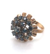 A VINTAGE CIRCA 1970's ASCENDING GEMSET CLUSTER RING. THE THREE GREENISH BLUE SAPPHIRE TIERS WITH