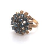 A VINTAGE CIRCA 1970's ASCENDING GEMSET CLUSTER RING. THE THREE GREENISH BLUE SAPPHIRE TIERS WITH