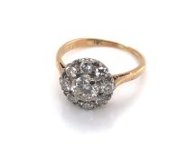 A VINTAGE DIAMOND CLUSTER RING. THE CENTRE DIAMOND SURROUND BY A HALO OF EIGHT FURTHER DIAMONDS. THE