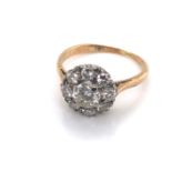 A VINTAGE DIAMOND CLUSTER RING. THE CENTRE DIAMOND SURROUND BY A HALO OF EIGHT FURTHER DIAMONDS. THE