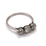 AN ANTIQUE PLATINUM AND THREE STONE OLD CUT DIAMOND RING. THE THREE GRADUATED OLD CUTS EACH IN A SIX