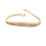 A VINTAGE THREE COLOUR RED, YELLOW AND WHITE BRICK STYLE GRADUATED BRACELET. THE CLASP STAMPED 9kt