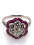 A RUBY AND DIAMOND ART DECO STYLE FLOWER CLUSTER RING. THE CENTRAL CLUSTER CONSISTING OF SEVEN OLD