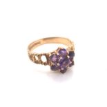 A 9ct YELLOW GOLD HALLMARKED SEVEN STONE AMETHYST CLUSTER RING. DATED 1972, BIRMINGHAM. FINGER