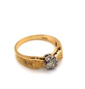 A VINTAGE SOLITAIRE DIAMOND RING WITH SHAPED BARKED SHOULDERS. APPROX DIAMOND WEIGHT 0.15cts.