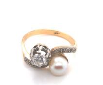 A VINTAGE DIAMOND AND PEARL TOI ET MOI BYPASS RING. THE CULTURED PEARL APPROX 6.1mm, THE ROUND