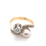 A VINTAGE DIAMOND AND PEARL TOI ET MOI BYPASS RING. THE CULTURED PEARL APPROX 6.1mm, THE ROUND