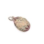 A VINTAGE SILVER AND RED ENAMEL FILIGREE WORK EGG PENDANT. UNHALLMARKED AND ASSESSED AS SILVER. DROP