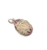 A VINTAGE SILVER AND RED ENAMEL FILIGREE WORK EGG PENDANT. UNHALLMARKED AND ASSESSED AS SILVER. DROP