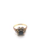 AN 18ct YELLOW GOLD HALLMARKED SAPPHIRE AND DIAMOND CLUSTER RING. DATED 1969, LONDON. FINGER SIZE