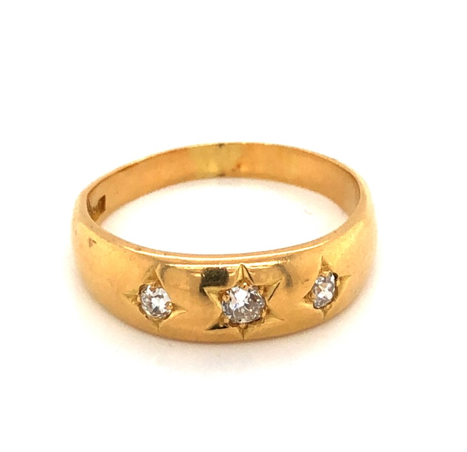 AN ANTIQUE THREE STONE OLD CUT DIAMOND GYPSY RING. THE SHANK STAMPED 18ct BH, AND ASSESSED AS 18ct