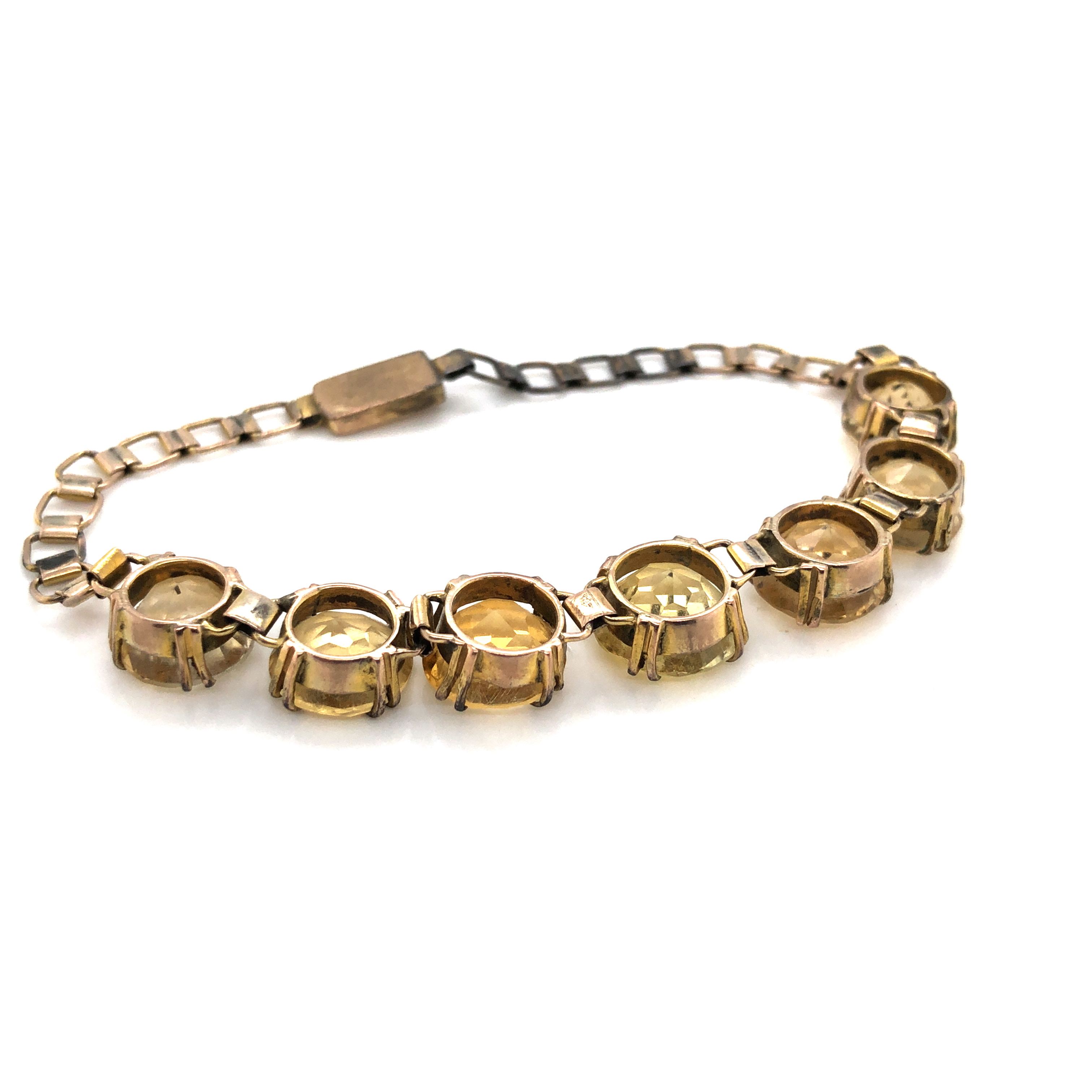 A VINTAGE CITRINE QUARTZ COSTUME BRACELET. FEATURING SEVEN GRADUATED CITRINE'S IN DOUBLE FOUR CLAW - Image 3 of 3