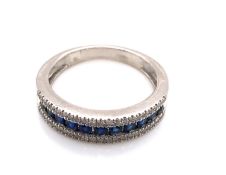 A PLATINUM HALLMARKED SAPPHIRE AND DIAMOND HALF ETERNITY RING. THE ROUND BRILLIANT SAPPHIRES IN A