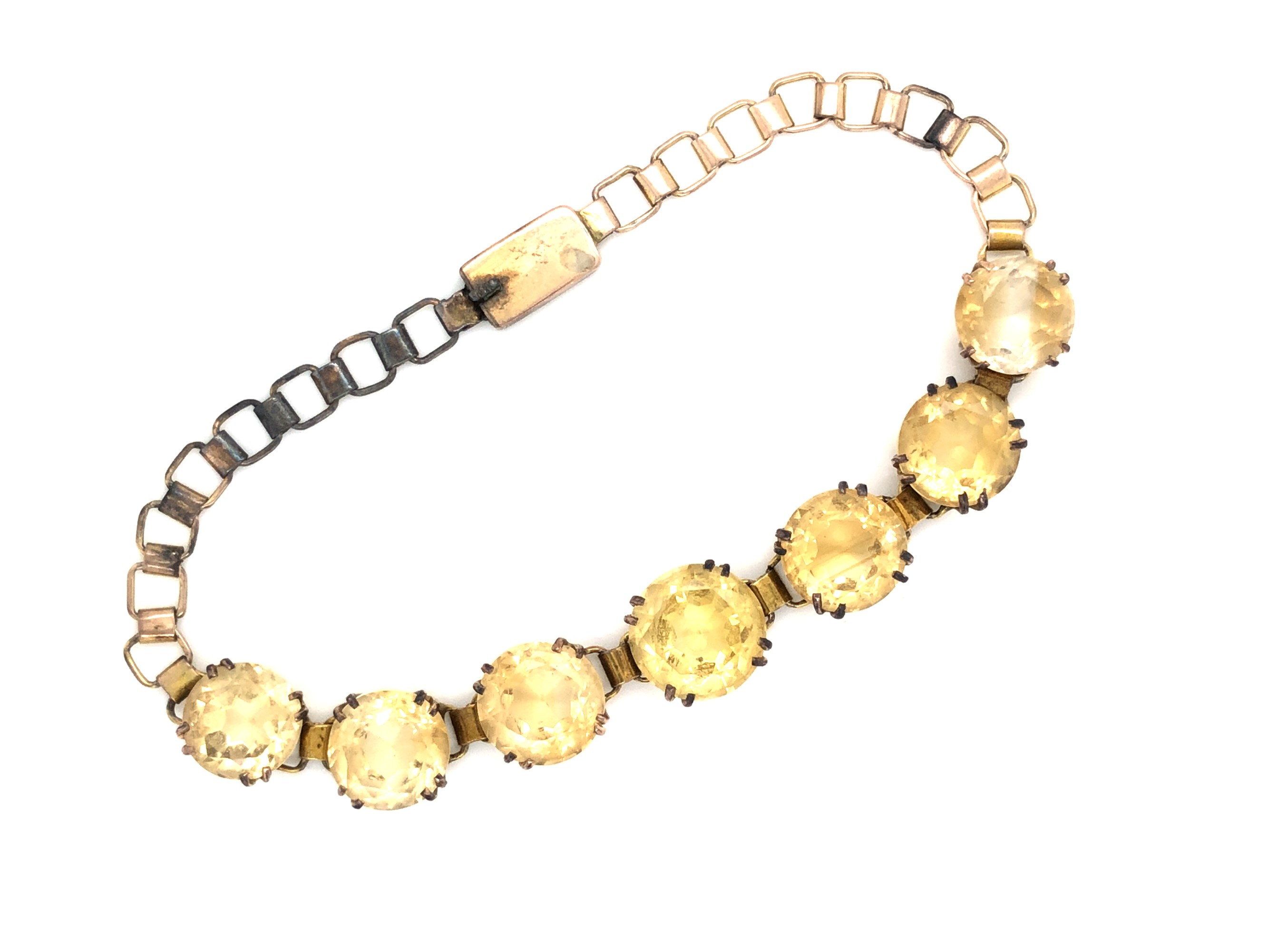 A VINTAGE CITRINE QUARTZ COSTUME BRACELET. FEATURING SEVEN GRADUATED CITRINE'S IN DOUBLE FOUR CLAW