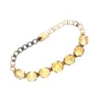 A VINTAGE CITRINE QUARTZ COSTUME BRACELET. FEATURING SEVEN GRADUATED CITRINE'S IN DOUBLE FOUR CLAW