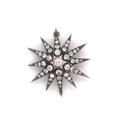 A VICTORIAN DIAMOND SPRAY STAR BROOCH. EACH POINT WITH A GRADUATED ARRAY OF OLD CUT DIAMONDS.