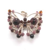 A LARGE AMBER AND FACET CUT BEADED SILVER BUTTERFLY PENDANT. UNMARKED AND ASSESSED AS 925 STERLING