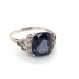 A VINTAGE PLATINUM STAMPED AND ASSESSED PURPLISH / GREY SPINEL AND PASTE STONE RING. THE SPINEL