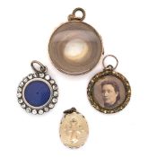 A GROUP OF FOUR ANTIQUE MOURNING AND PORTRAIT LOCKETS. THE LARGEST DIAMETER 2.5cms. HALLMARKED 1906,