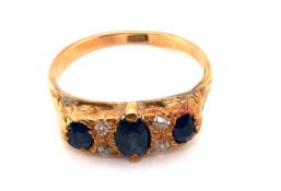 AN ANTIQUE SAPPHIRE AND DIAMOND CARVED HALF HOOP RING. THE SHANK STAMPED 18ct AND ASSESSED AS 18ct