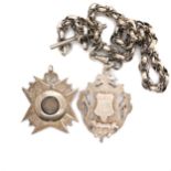 TWO ANTIQUE HALLMARKED SILVER PRESENTATION WATCH CHAIN FOBS, SUSPENDED ON A CONTINENTAL WHITE