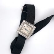 AN ART DECO DIAMOND AND PLATINUM LADIES COCKTAIL WATCH. UNHALLMARKED AND STAMPED TO INSIDE COVER ALL