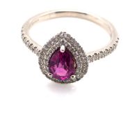 A PLATINUM 950 HALLMARKED TEARDROP PINK SAPPHIRE AND DIAMOND HALO SET RING. THE PINK SAPPHIRE 6.5