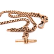A 9ct OLD ROSE GOLD CURB LINK ALBERT POCKET WATCH CHAIN COMPLETE WITH T-BAR AND A DOG TOOTH CLASP AT