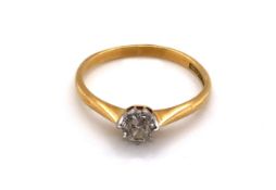 AN 18ct YELLOW GOLD AND PLATINUM SOLITAIRE DIAMOND RING. THE OLD CUT DIAMOND IN A RAISED EIGHT