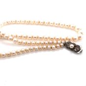 A MIKIMOTO GRADUATED PRINCESS STRING OF CULTURED AKOYA PEARLS, COMPLETE WITH A SILVER PEARL SET