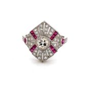 AN OLD CUT DIAMOND AND FANCY MIXED CUT RUBY ART DECO STYLE FLARED PANEL RING. THE CENTRAL DIAMOND IN