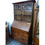A GEORGE III OAK BUREAU BOOKCASE, THE GLAZED DOORS TO THE TOP EACH OF TWO LANCET TOPPED PANELS,
