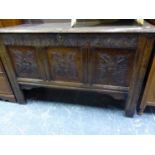 AN ANTIQUE OAK COFFER, THE THREE FRONT PANELS CARVED WITH FOLIAGE QUATREFOILS. W 118 x D 50 x H 72cm